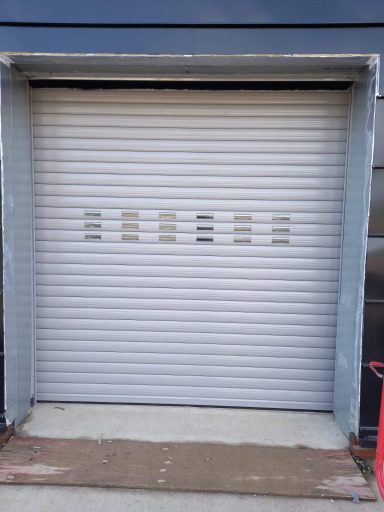 Punched and glazed roller shutter